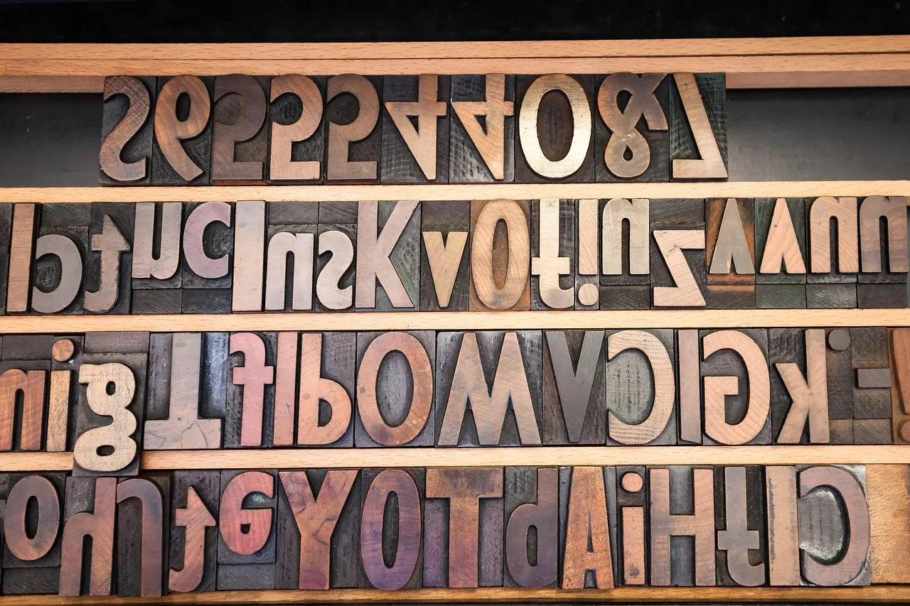 Case of large wooden letterpress letters and figures, reversed